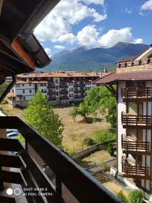 a view of the mountains from the balcony of a building at Bansko Belvedere Apartament in Bansko