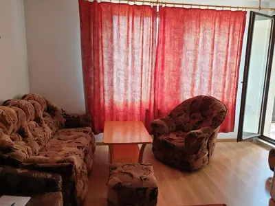 a living room with two chairs and a table at Снежанка in Pamporovo