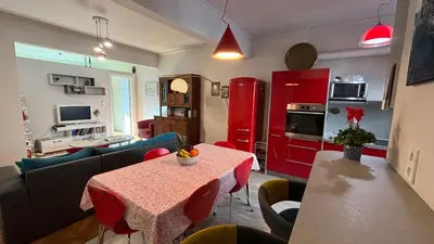 a living room with a table and a kitchen at Top Central Place with 2 bedrooms in Sofia in Sofia