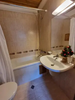 a bathroom with a sink and a toilet and a tub at Pirin Golf Hotel Private Studios in Razlog