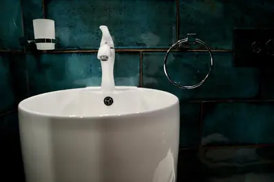 a white sink with a faucet in a bathroom at HIDDEN BANK: Digger's Dream in Plovdiv