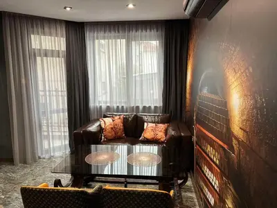 a living room with a leather couch and a table at HIDDEN BANK: Digger's Dream in Plovdiv