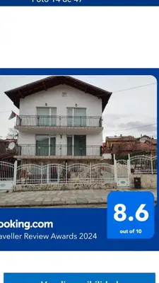 a picture of a white house with a balcony at Стаи за гости РИЛА in Rila