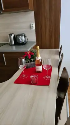a bottle of wine and two glasses on a table at Luxury Apartment in Belvedere Club Hotel in Bansko