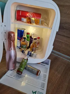 an open refrigerator filled with lots of alcohol at Mountain Paradise in Aparthotel Borovets Gardens in Borovets