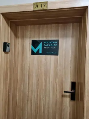 a sign on the door of a mountain service apartment at Mountain Paradise in Aparthotel Borovets Gardens in Borovets