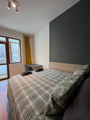 a bedroom with a bed and a desk in it at HOME 12 in Sofia