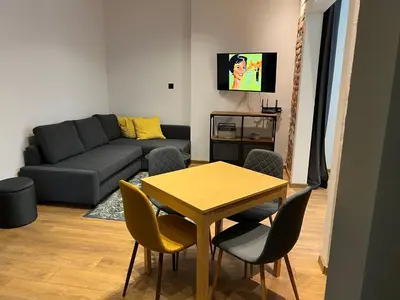 a living room with a table and a couch at HOME 12 in Sofia