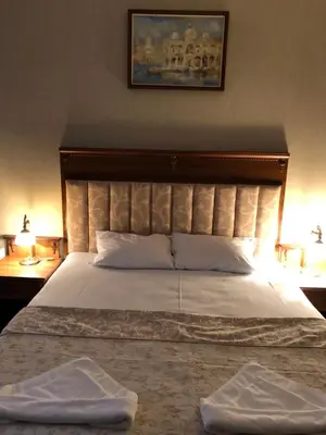 a bedroom with a large bed with two towels on it at APARTHOTEL BON BON in Sofia