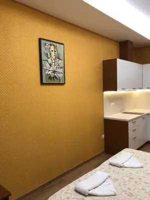 a room with two beds and a picture on the wall at APARTHOTEL BON BON in Sofia