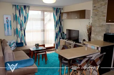 a living room with a couch and a table at Victoria apartments 1 in Velingrad