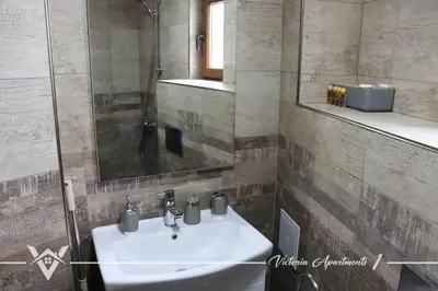 a bathroom with a sink and a mirror at Victoria apartments 1 in Velingrad