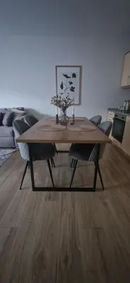 a wooden table in a living room with a couch at Free SPA Pirin lodge cosy apartment in Bansko