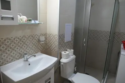 a bathroom with a toilet and a sink and a shower at Nikol 2 Deluxe in Velingrad