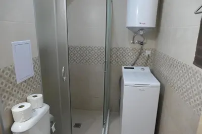a small bathroom with a shower and a toilet at Nikol 2 Deluxe in Velingrad