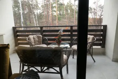 a balcony with a table and chairs and a window at Nikol 2 Deluxe in Velingrad