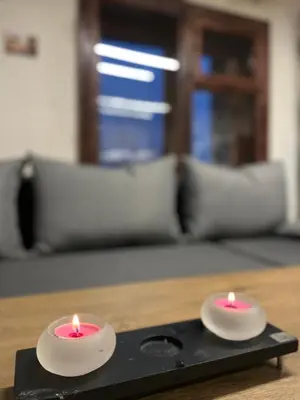 two candles sitting on top of a table at Kassandrov Guest House Ravnogor/ Касандрова къща Равногор in Yasă-Koriya
