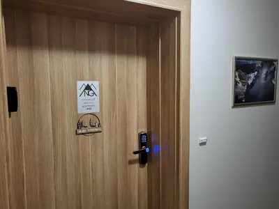 a door with a sign on it with a phone on it at Pinewood ANG luxurious apartment A43, Borovets Gardens in Borovets