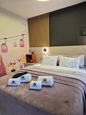 a bedroom with a large bed with three pillows on it at Pinewood ANG luxurious apartment A43, Borovets Gardens in Borovets