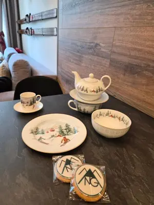 a table with plates and a tea pot on it at Pinewood ANG luxurious apartment A43, Borovets Gardens in Borovets