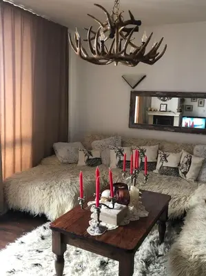 a living room with a table with red candles on it at BREATHTAKING Mountain view 3 bedrooms appartement in Bansko