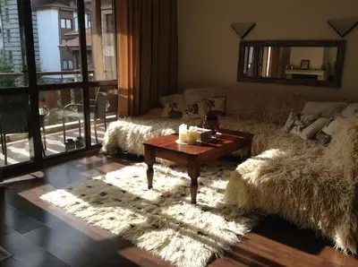 a living room with a couch and a coffee table at BREATHTAKING Mountain view 3 bedrooms appartement in Bansko