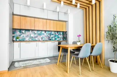 a kitchen with a wooden table and blue chairs at Downtown - Netflix - AC - Next to Metro and Train in Sofia