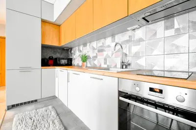 a kitchen with white cabinets and a sink at Downtown - Netflix - AC - Next to Metro and Train in Sofia