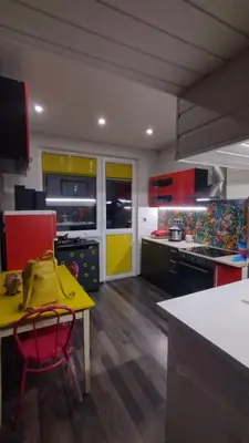 a kitchen with yellow and red cabinets and a yellow table at Top center Art deluxe apartment near to Aleksander Nevsky cathedral in Sofia