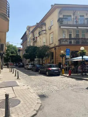 a city street with cars parked in front of buildings at Top center Art deluxe apartment near to Aleksander Nevsky cathedral in Sofia