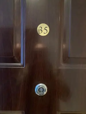 a wooden door with the number on it at Studio Detelina Residence in Bansko