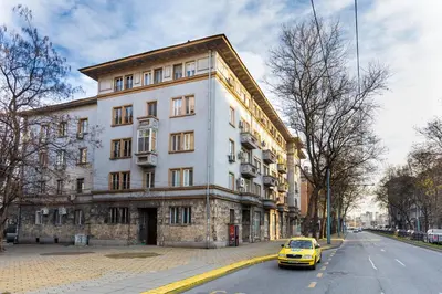a yellow car parked in front of a building at Stella 1&2 - Pink and Grey Studios near the Singing Fountains by Flat Mаnager in Plovdiv