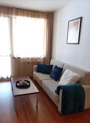 a living room with a couch and a table at Belvedere Holiday Club 101 in Bansko