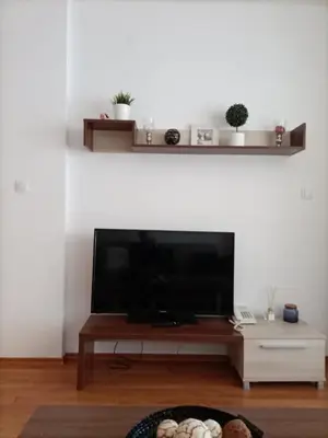 a living room with a large flat screen tv at Belvedere Holiday Club 101 in Bansko