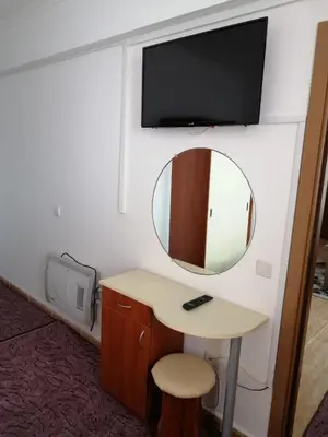 a room with a mirror and a desk and a tv at GRAND MONASTERY Apartment ``WHITE TALE`` in Pamporovo