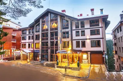 a large building in a city with a street at Pamporovo Central Apartments in Pamporovo