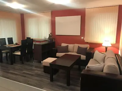a living room with a couch and a table at Pamporovo Central Apartments in Pamporovo