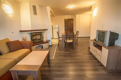 a living room with a couch and a tv at Pamporovo Central Apartments in Pamporovo