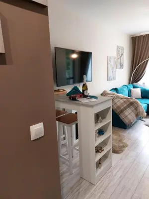 a room with a desk and a living room at MAGRI Luxurious Apartment A42 Borovets Gardens in Borovets