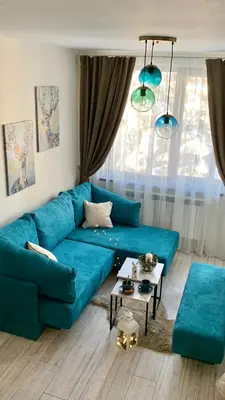 a living room with a blue couch and a table at MAGRI Luxurious Apartment A42 Borovets Gardens in Borovets
