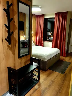 a bedroom with a bed and a mirror on the wall at Pinewood ANG luxurious apartment A32 in Borovets