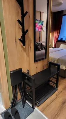 a bathroom with a mirror and a chair in a room at Pinewood ANG luxurious apartment A32 in Borovets
