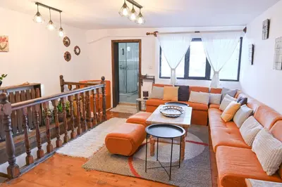 a living room with a couch and a table at 4 BDR House Monument of Culture & Architecture by Flat Mаnаger in Bansko