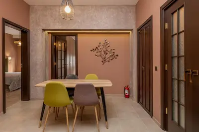 a dining room with a table and chairs at ~Angels ~ Two-Bedroom Deluxe Flat in City Centre in Sofia