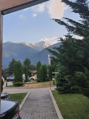 a view of a driveway with mountains in the background at Rustic Spa at Pirin Golf in Razlog
