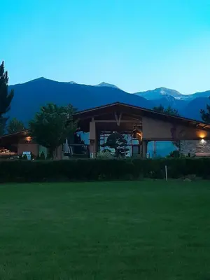 a house with a green lawn in front of it at Rustic Spa at Pirin Golf in Razlog