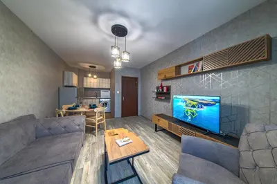 a living room with a couch and a flat screen tv at Colors of Nature in Stylish Flat in Pamporovo by Flat Mаnager in Pamporovo