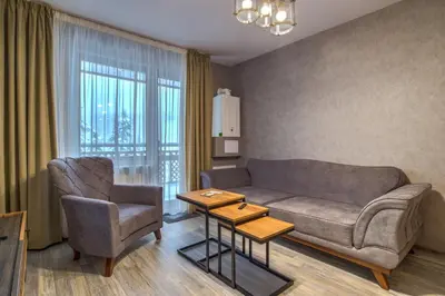 a living room with a couch and a chair at Colors of Nature in Stylish Flat in Pamporovo by Flat Mаnager in Pamporovo