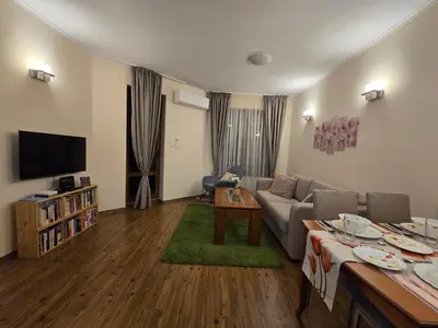a living room with a couch and a tv at Bansko Boutique Apartments - Flora Boutique in Bansko