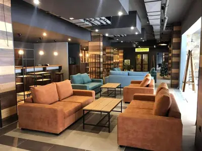 a lobby with couches and tables in a store at Borovets Gardens Ski Apartment in Borovets